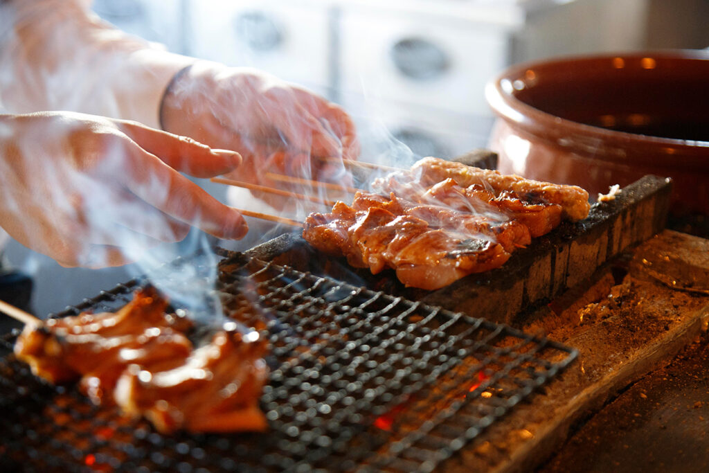 The craftsman is grilling yakitori Japanese food skewers chicken